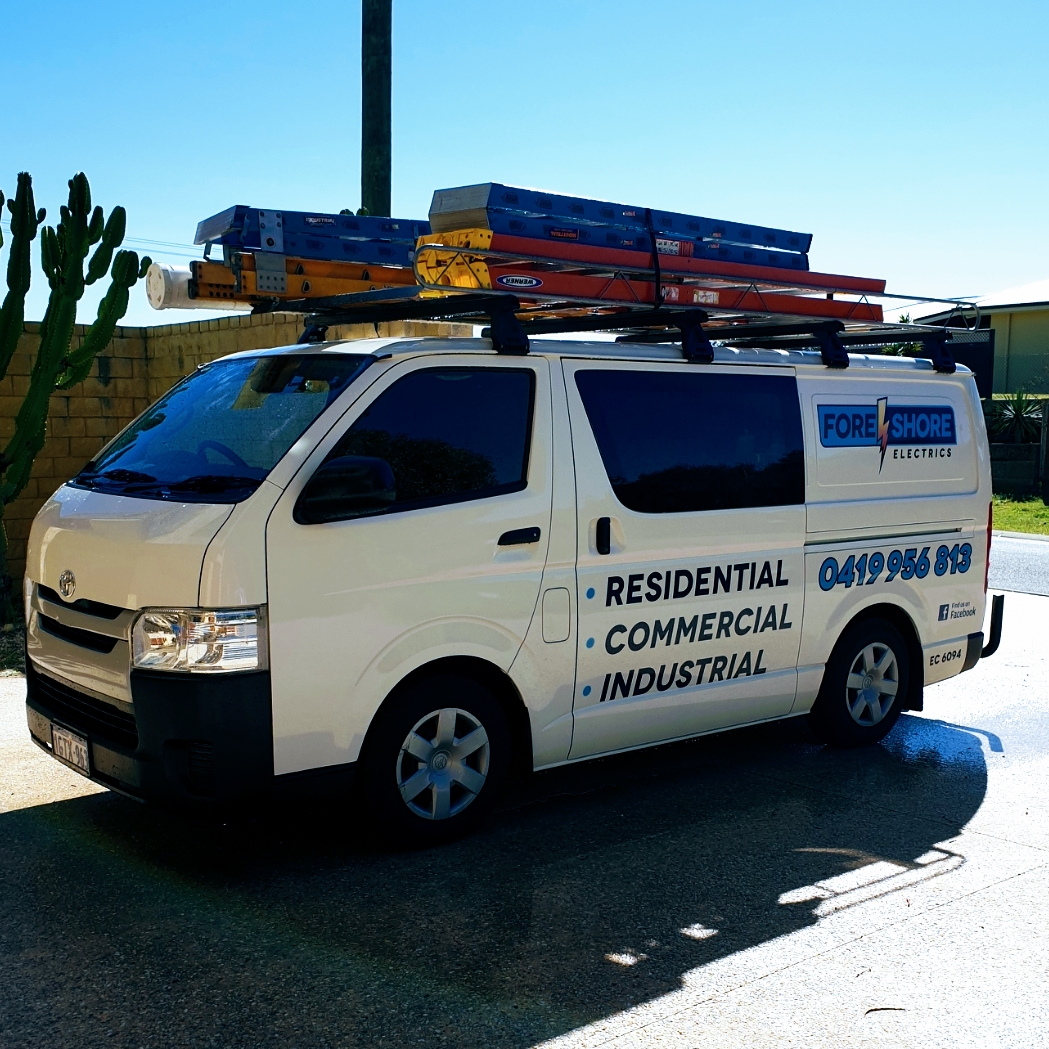 The Foreshore Electrics work van, ladders on the roof rack, signwritten residential commercial industrial