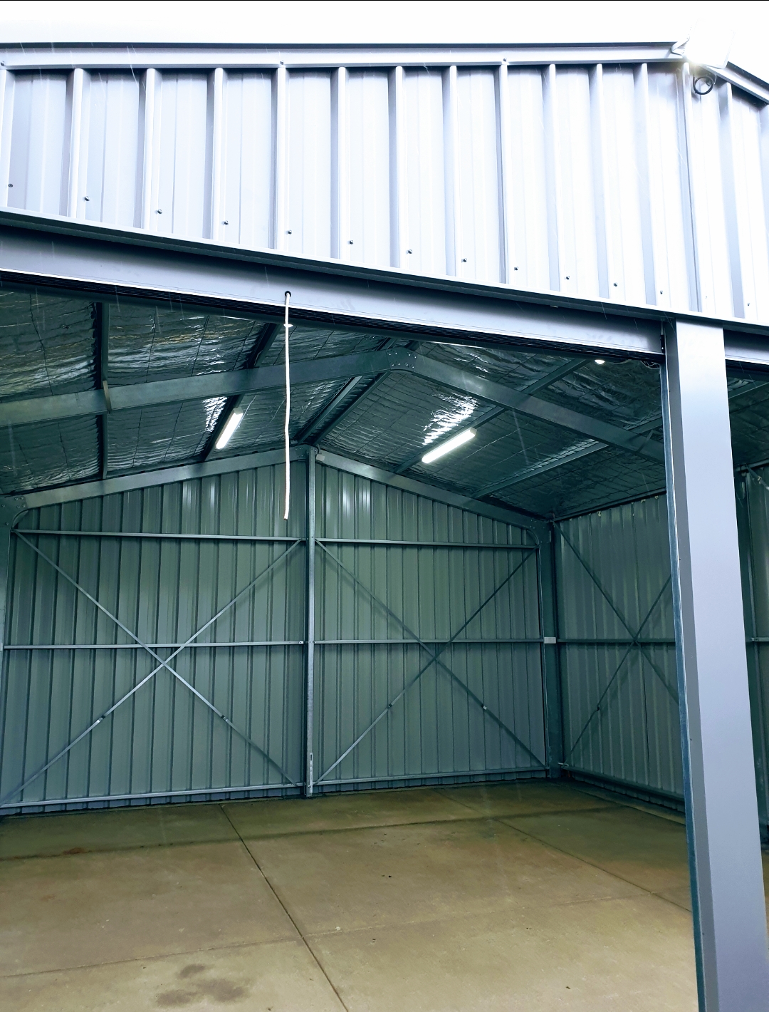 A new Colorbond shed interior with LED batten lights fitted and running