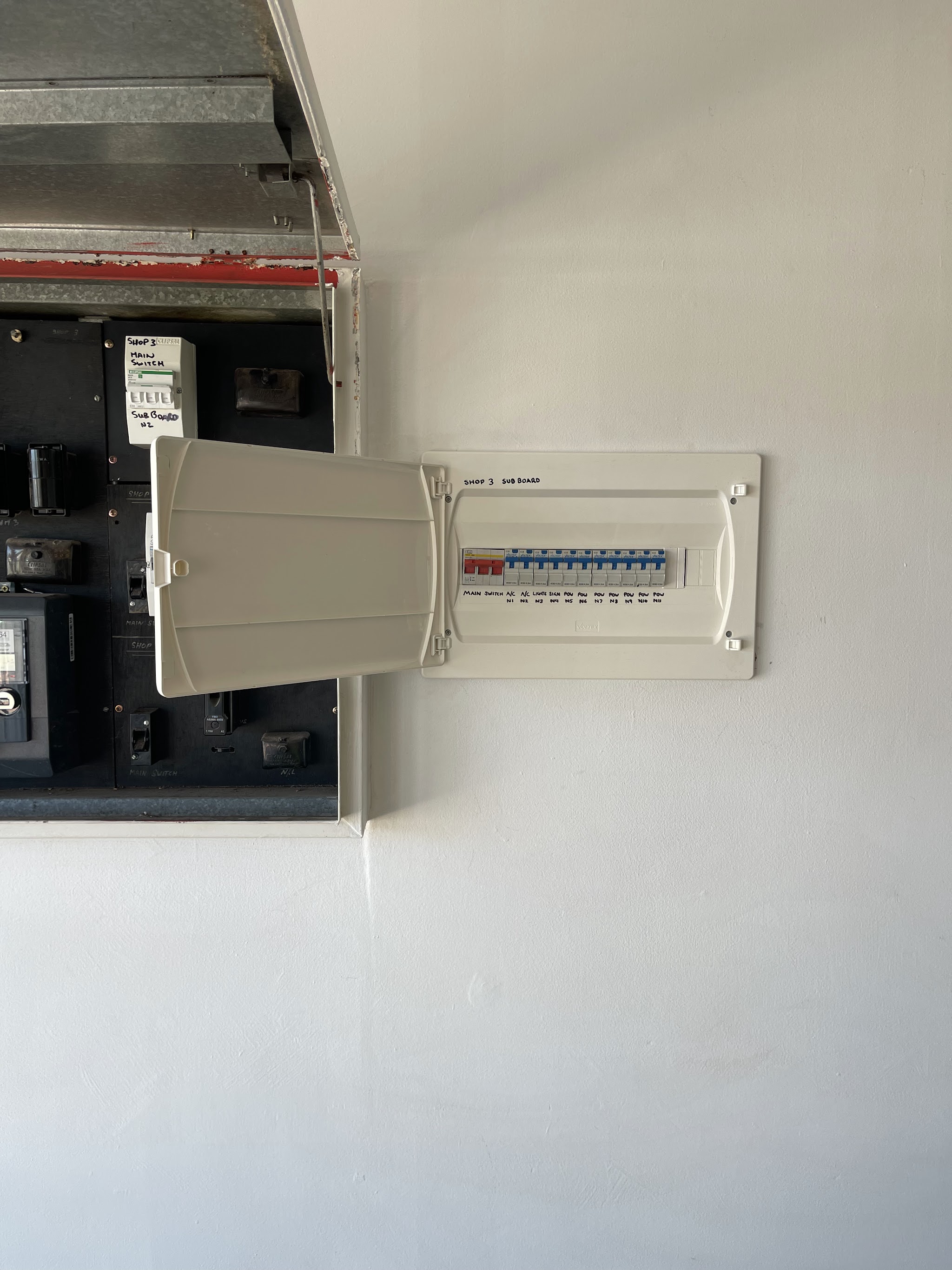 A new labelled sub board installed for a shop tenancy beside the old board